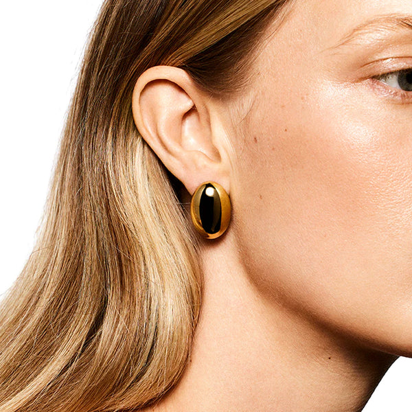 Model wearing the Camille stud earrings in gold colour from the brand LIÉ STUDIO