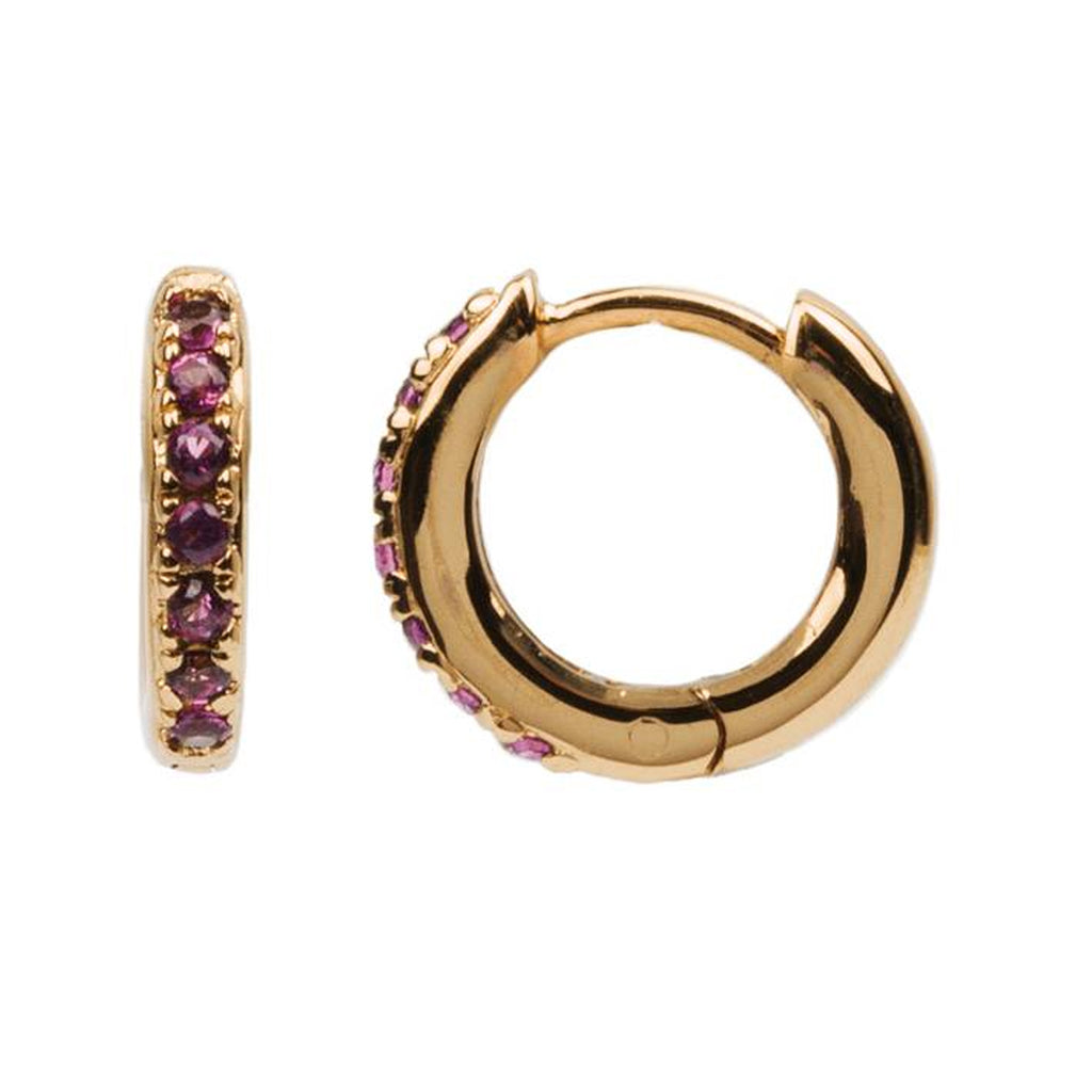 The creole earrings in gold and ruby colour from the brand ALL THE LUCK IN THE WORLD