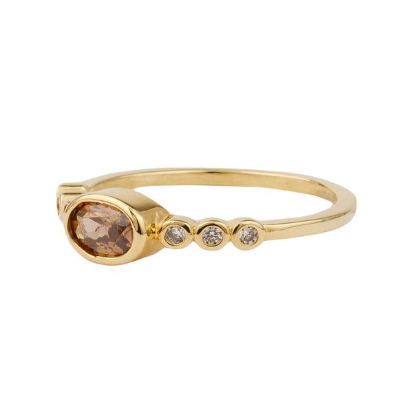 The ellips ring in gold and brown color from the brand ALL THE LUCK IN THE WORLD