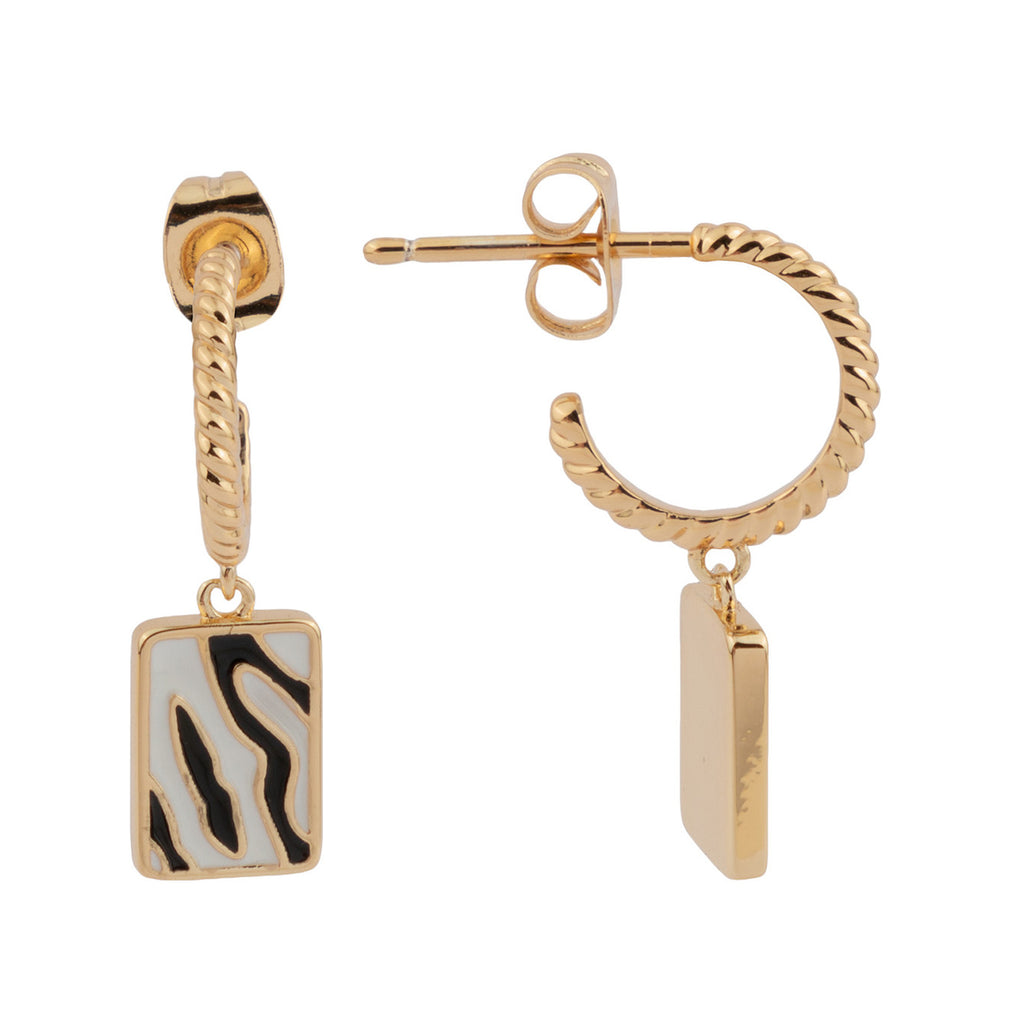 The zebra rectangle earrings in gold, white and black colour from the brand ALL THE LUCK IN THE WORLD