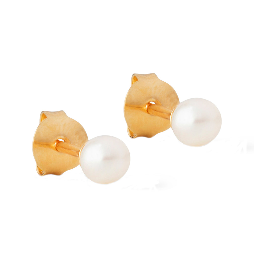 The Coco stud earrings in gold and pearl from the brand ENAMEL COPENHAGEN