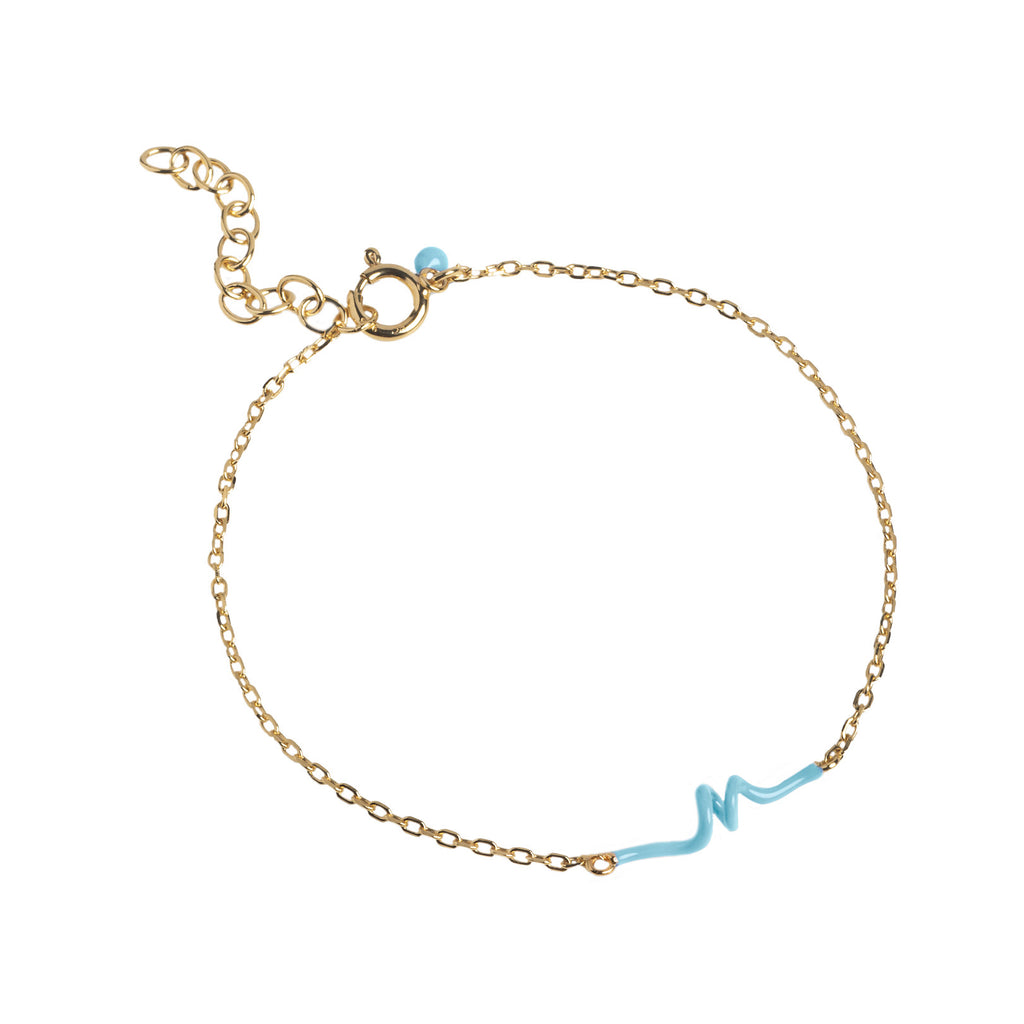 The twist bracelet in gold and icy-blue colour from the brand ENAMEL COPENHAGEN