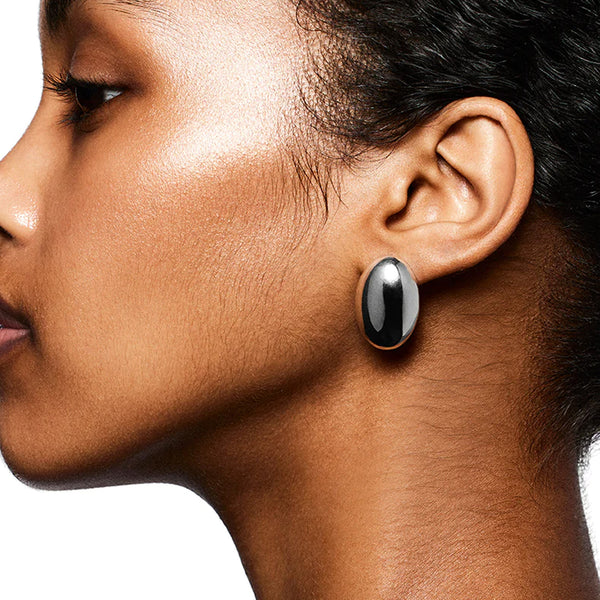 Model wearing the Camille stud earrings in silver colour from the brand LIÉ STUDIO