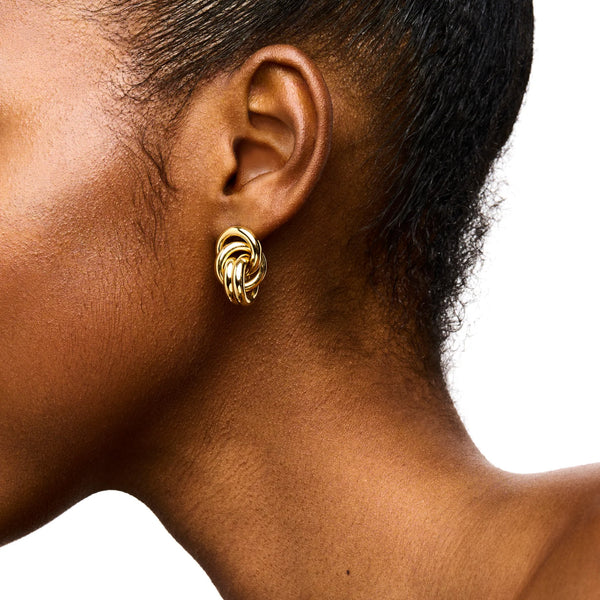 Model wearing the Vera stud earrings in gold colour from the brand LIÉ STUDIO