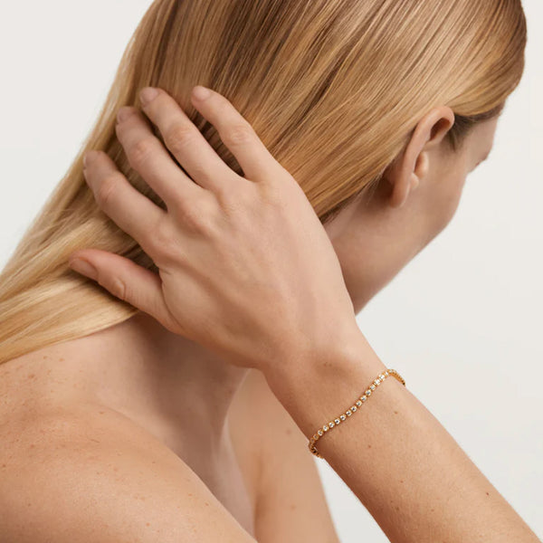 Model wearing the Florence bracelet in gold and clear colours from the brand P D PAOLA