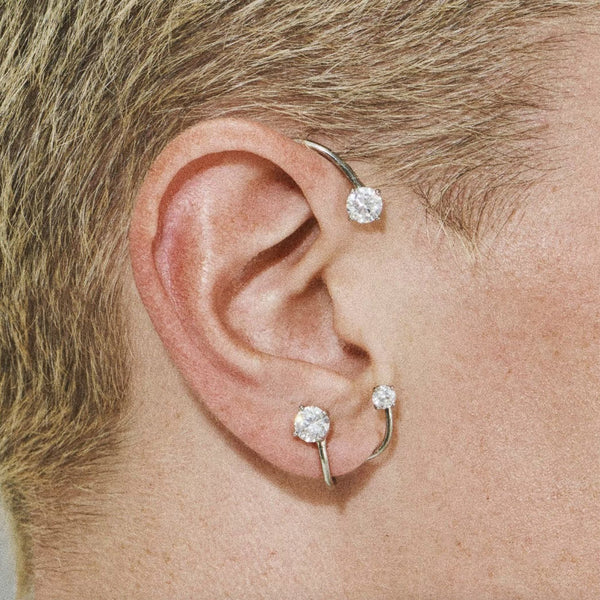 Model wearing the Three Point ear cuffs in silver colour from the brand PANCONESI